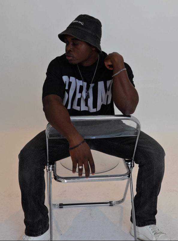 Person sitting on a clear chair against a white background