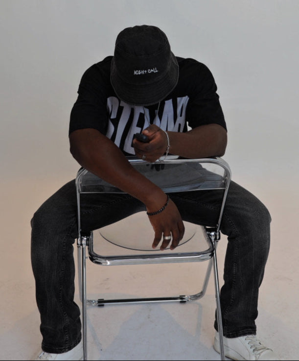 Person sitting on a chair against a plain white background
